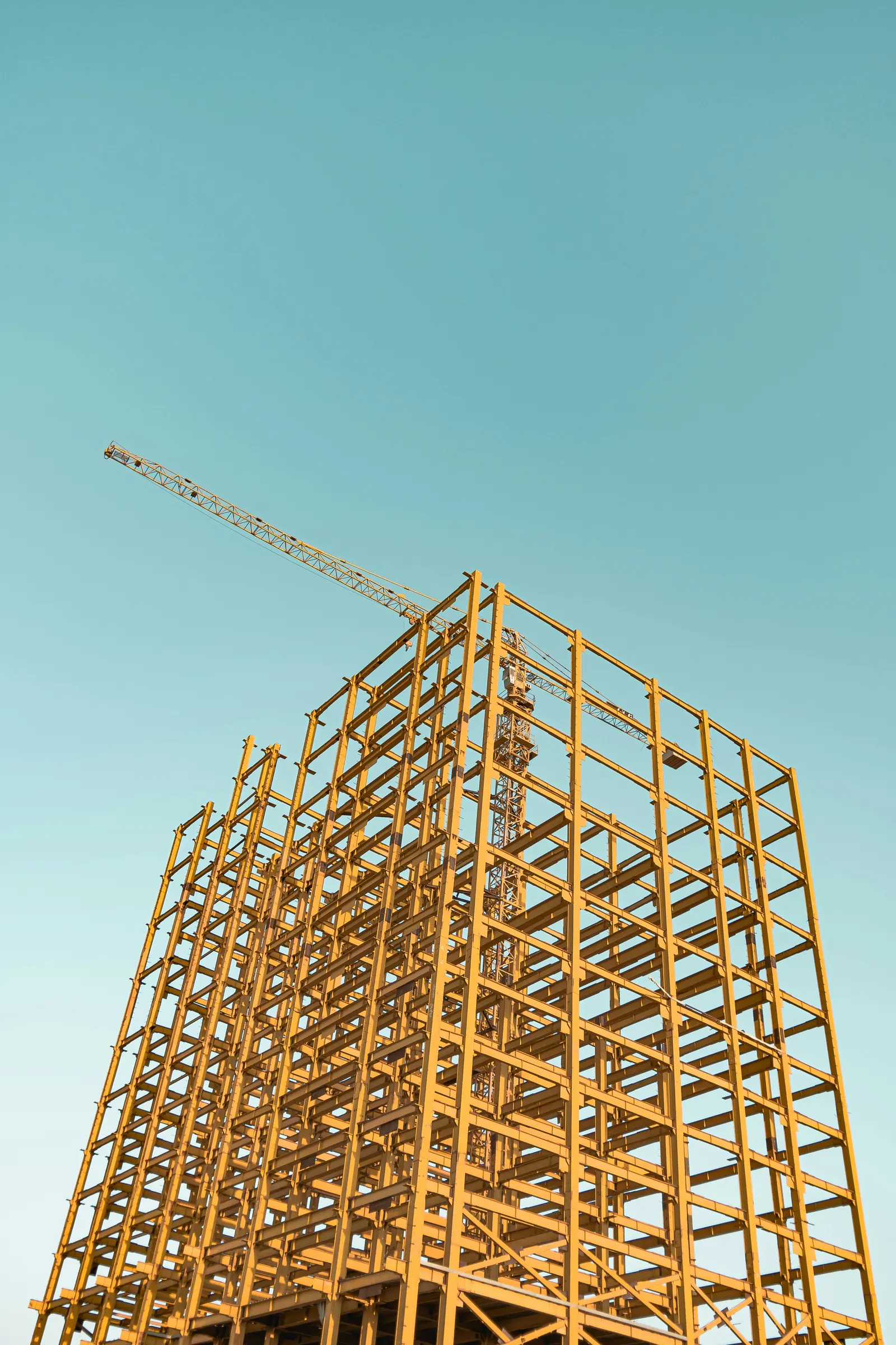 Architectural scaffolding rising upward, representing a structured business framework.